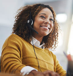 African woman, call center agent or smile with voip for consulting, listening or contact us in office. Female consultant, customer service or tech support crm with headphones, microphone or help desk.