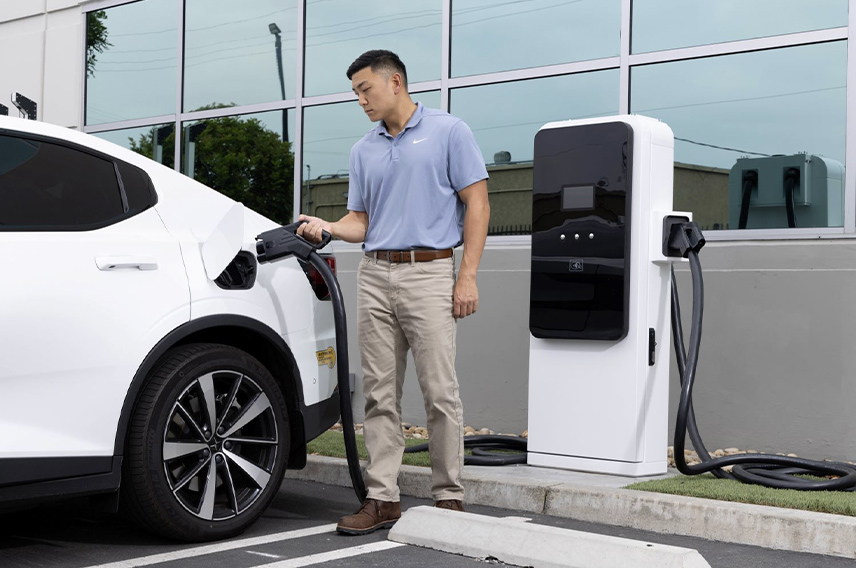 A person charging an electric vehicle 